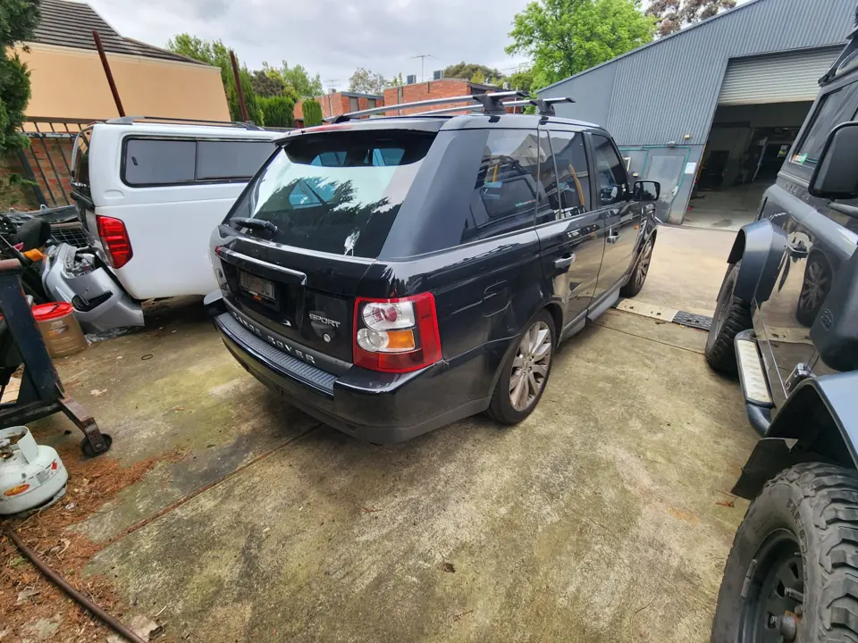 Dark SUV parked beside other unwanted vehicles