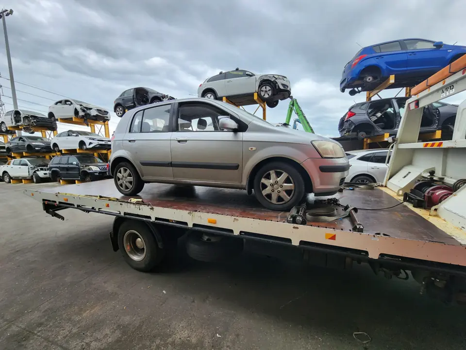 Silver sedan on a flatbed truck