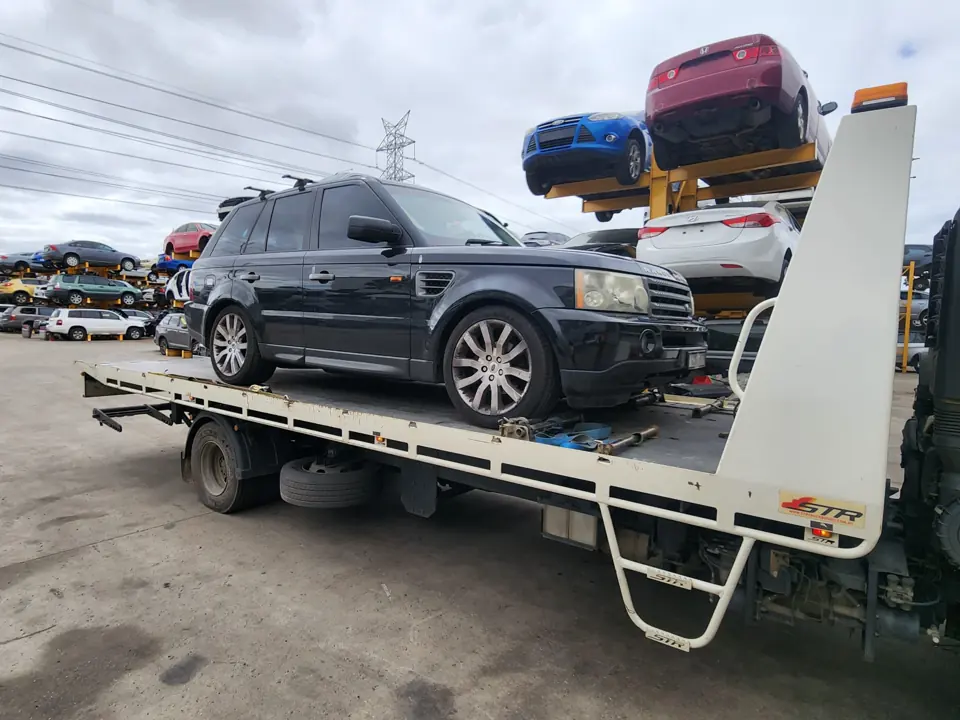 Dark SUV loaded on a vehicle transporter