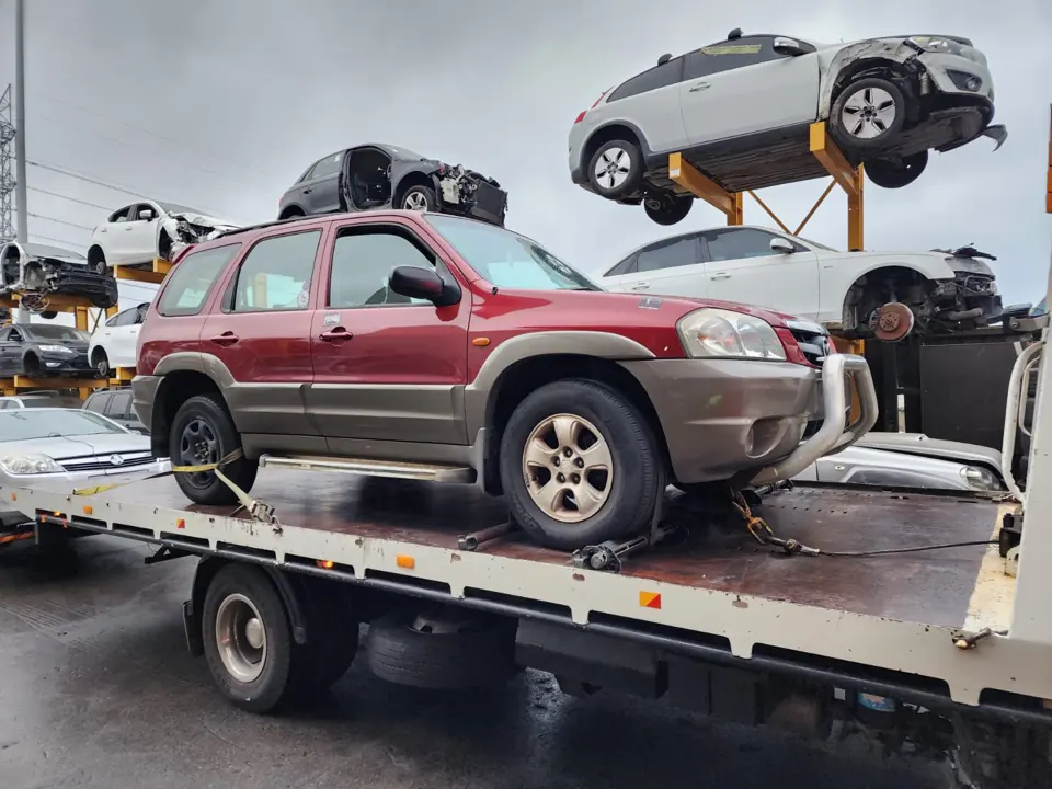Red and silver SUV on a flatbed