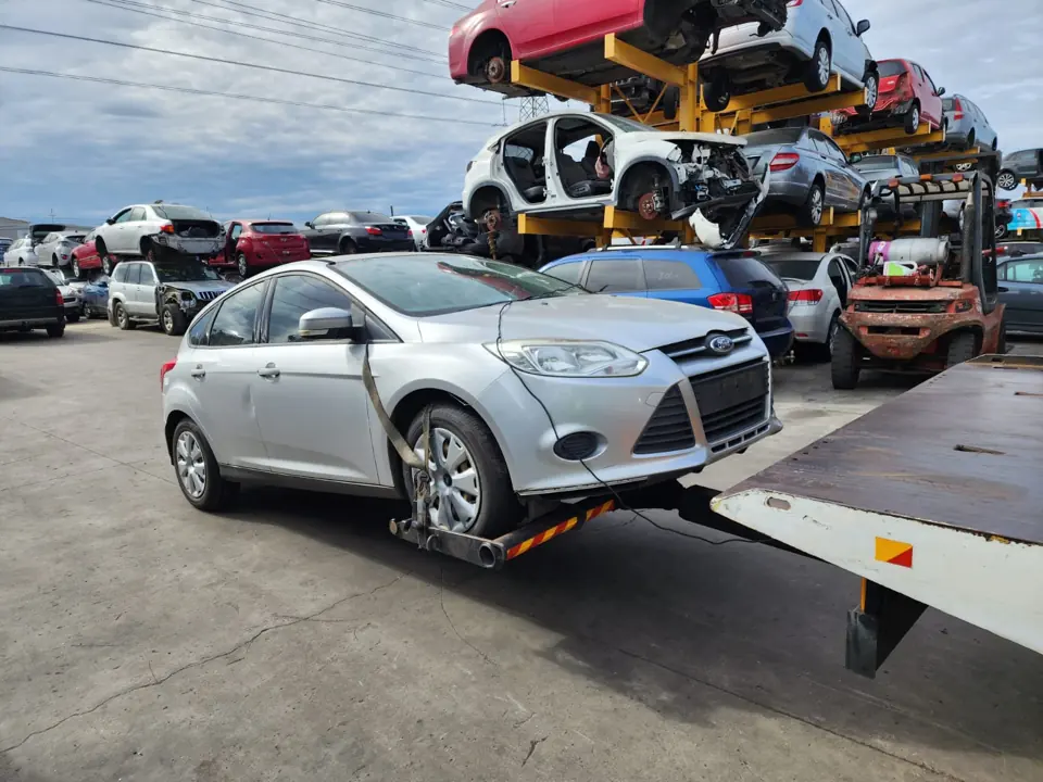 Silver sedan in a vehicle recycling yard