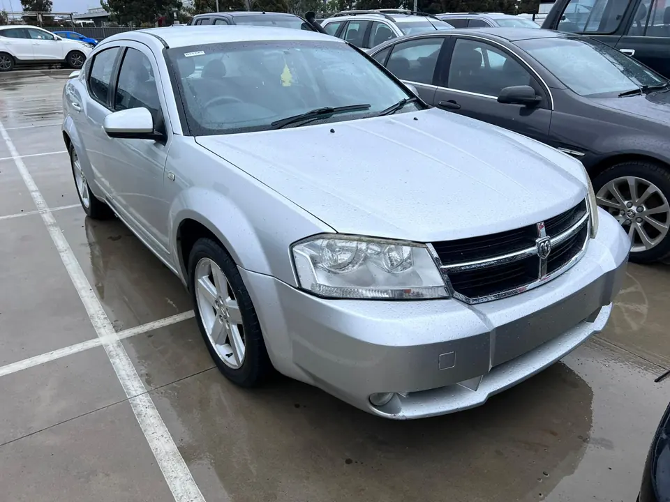Silver sedan in a vehicle yard