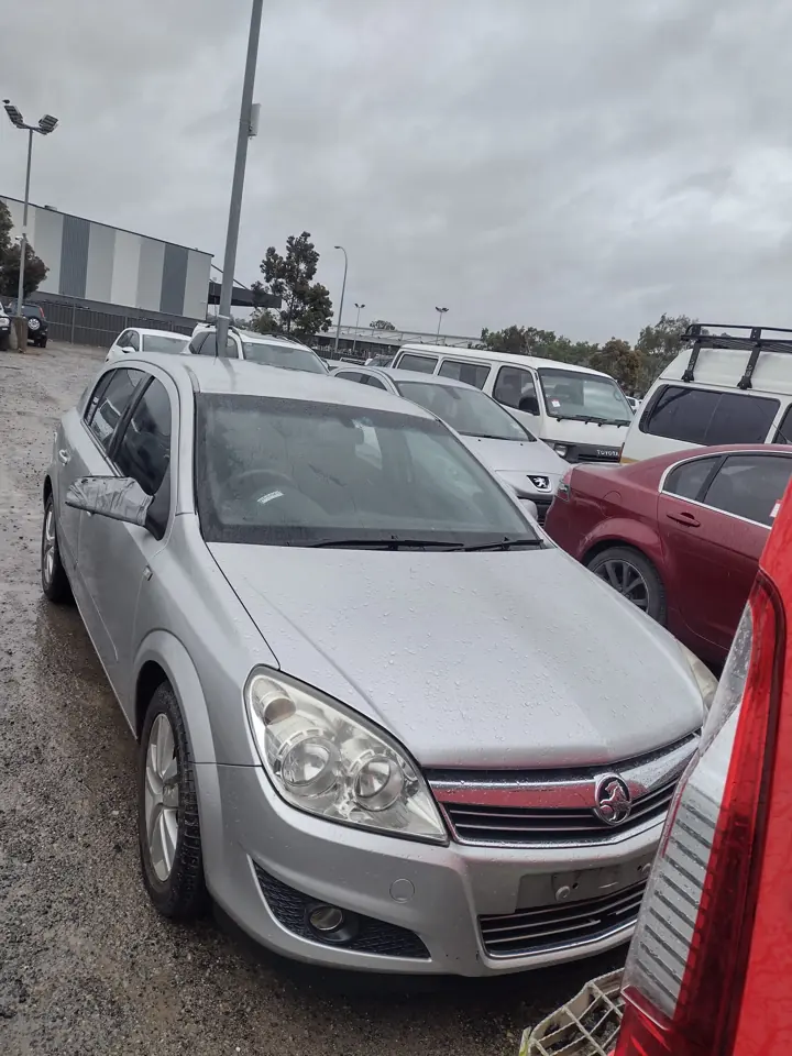 Silver hatchback in a vehicle yard