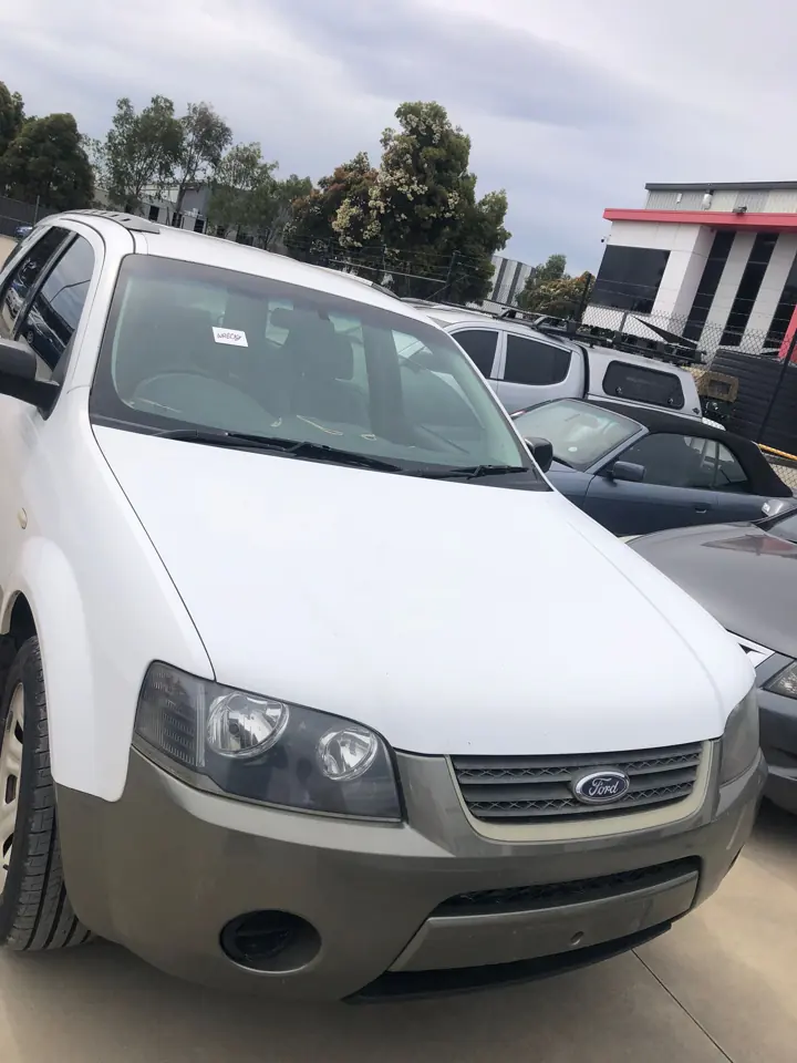 White SUV with front bumper wear