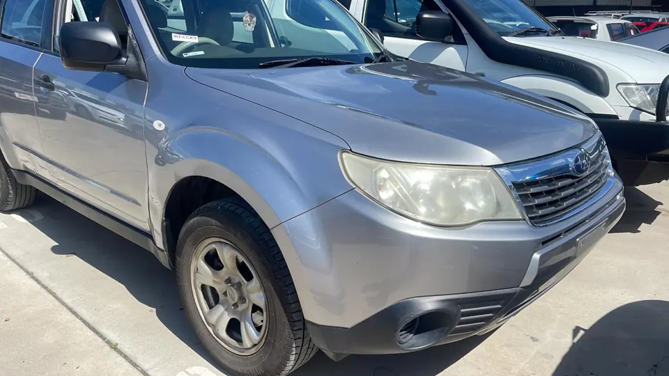 Silver SUV parked beside other vehicles