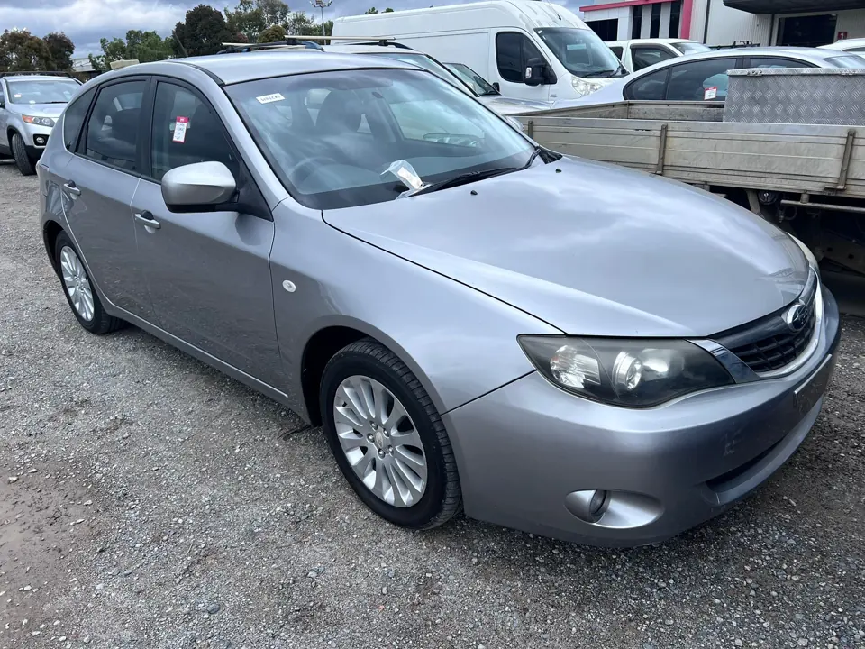 Silver sedan parked alongside other cars