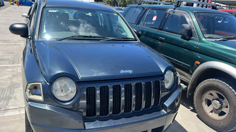 Blue SUV parked alongside other vehicles