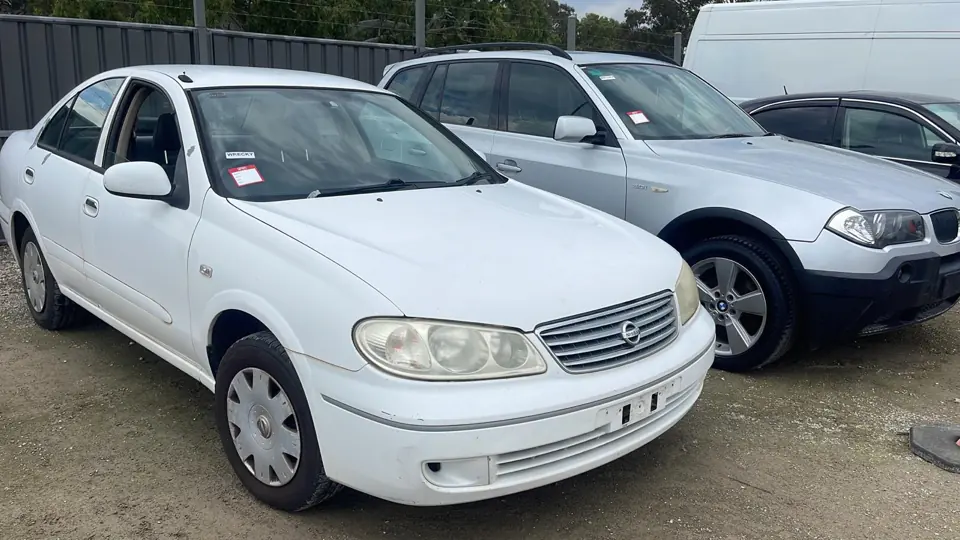 White sedan in a vehicle yard
