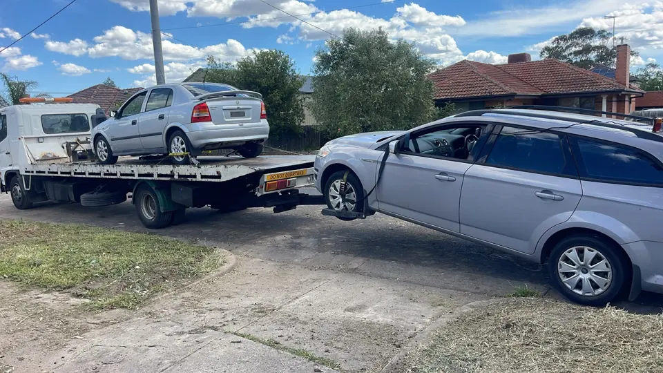 Vehicles beside a recovery truck