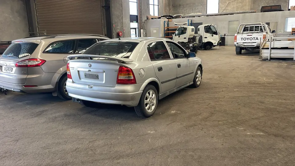 White hatchback in a vehicle yard