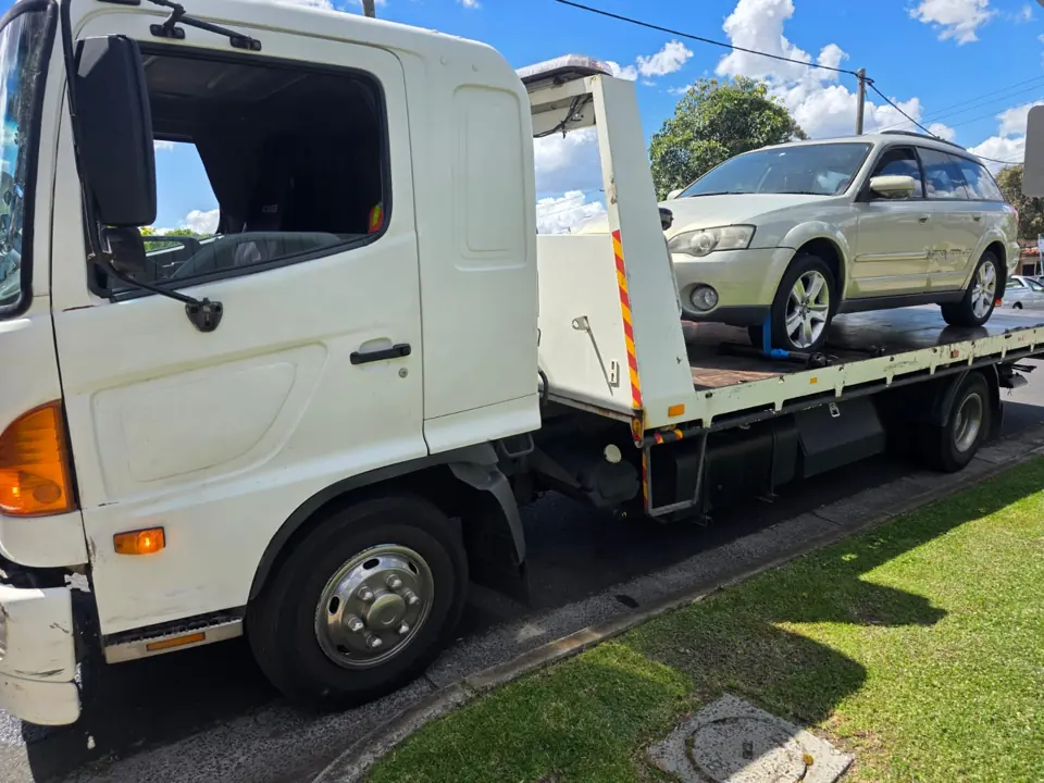 Silver vehicle on a tow truck