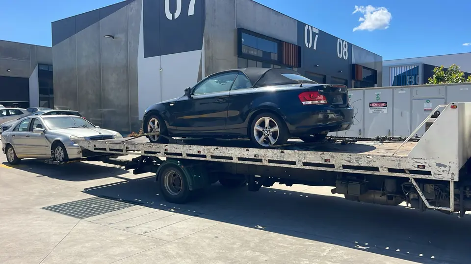 Dark vehicle on a flatbed truck
