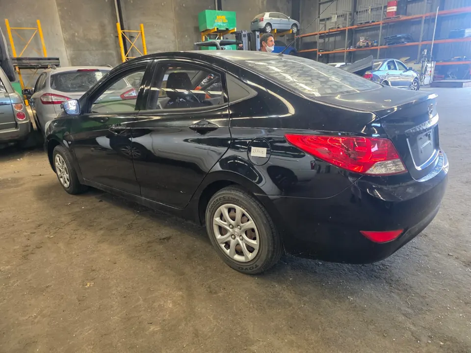 Dark hatchback inside a workshop
