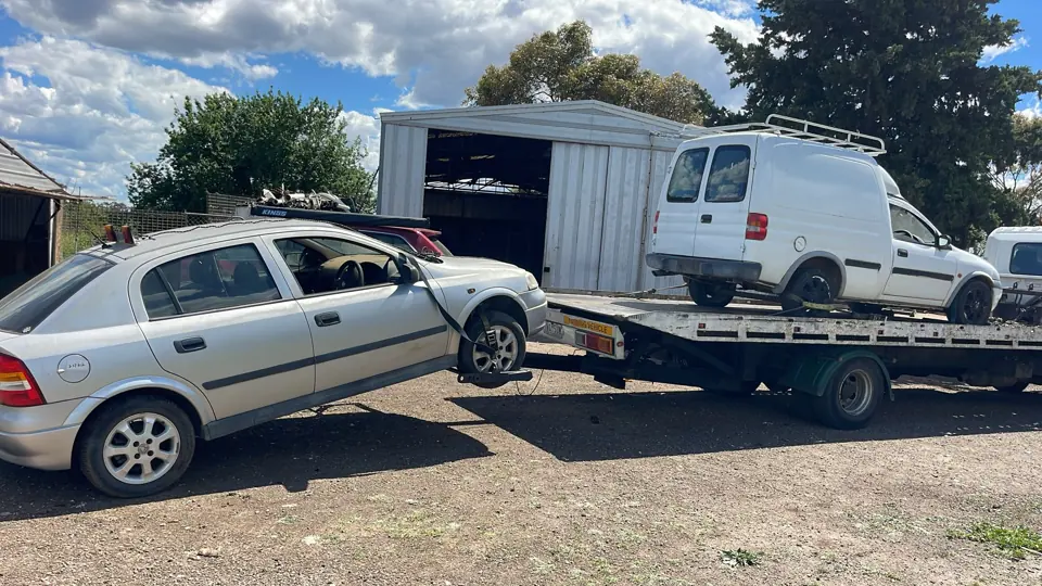 White SUV beside a tow truck