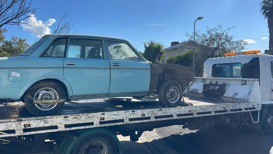 Older vehicle loaded on a flatbed