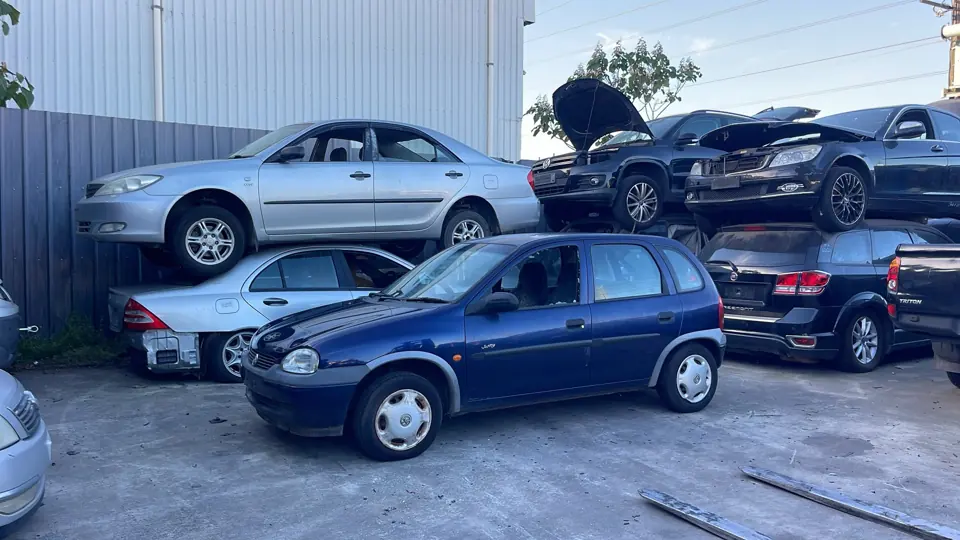 Blue sedan in a vehicle yard