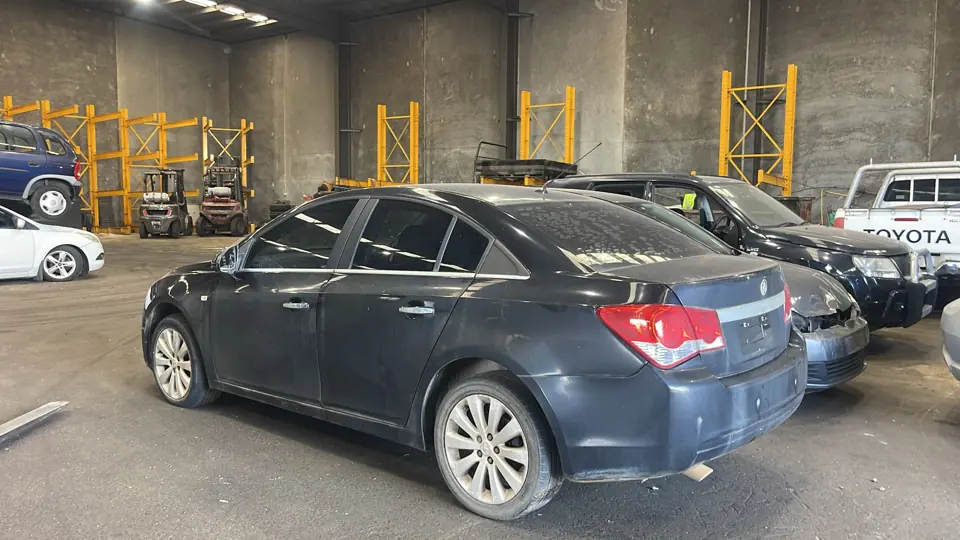 Dark sedan inside a workshop