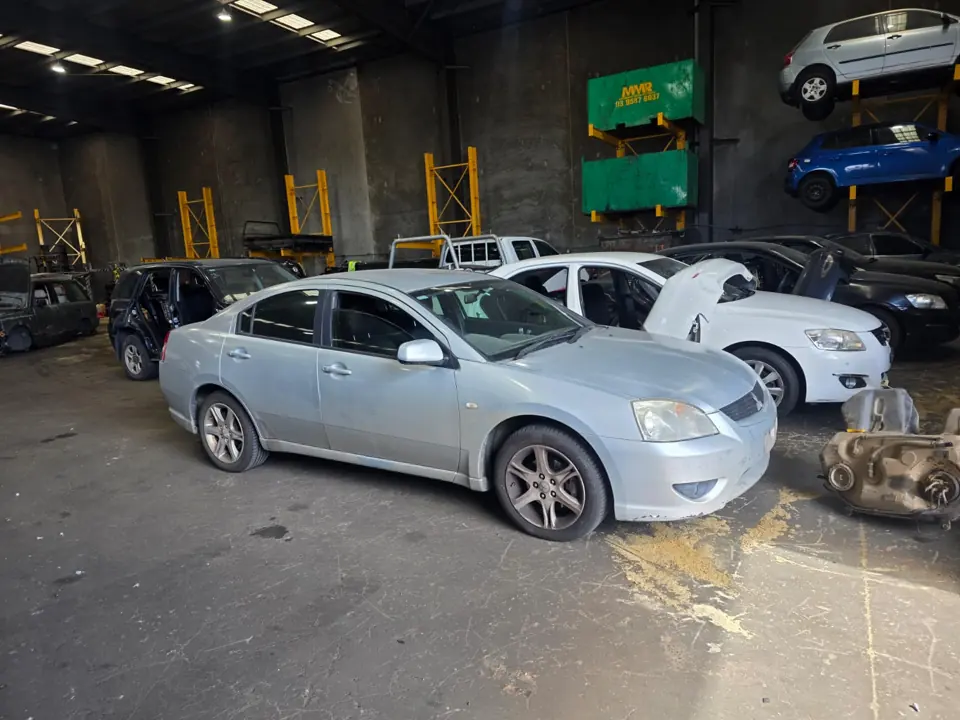 White sedan inside a workshop