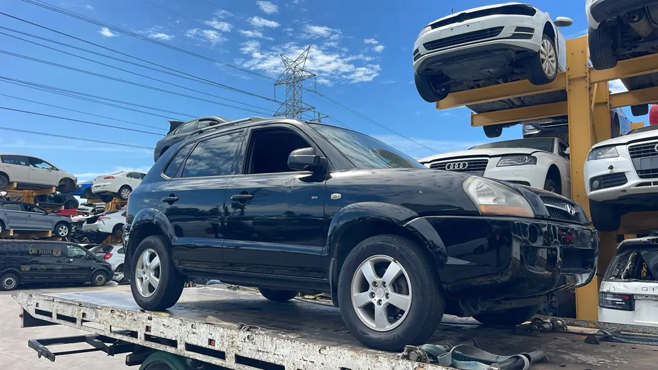 Dark SUV on a flatbed truck