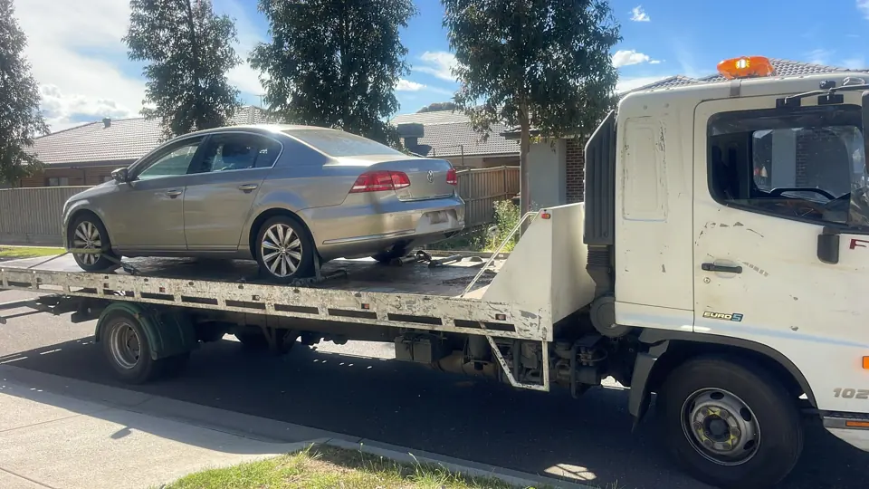 Silver car loaded for transport