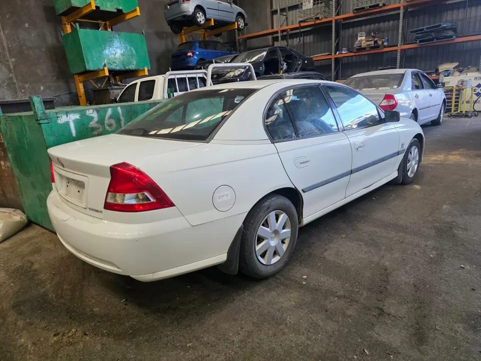 White sedan parked indoors