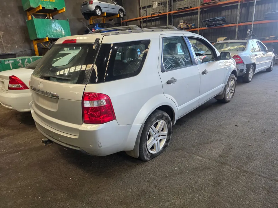 Silver hatchback inside a workshop