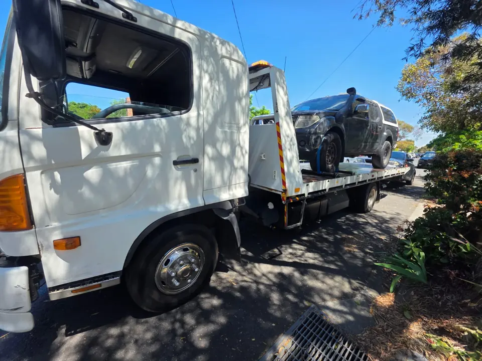 White recovery truck in a yard