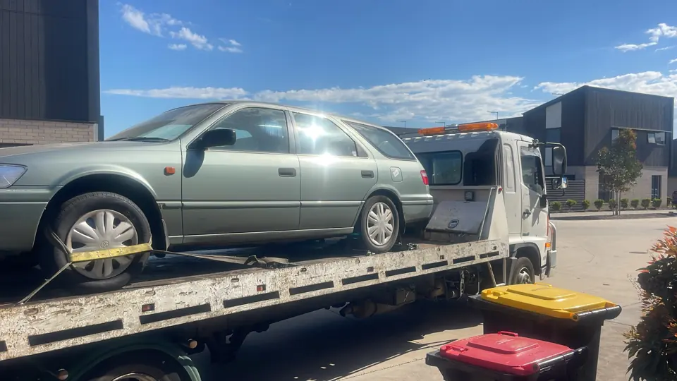 Silver vehicle secured for transport