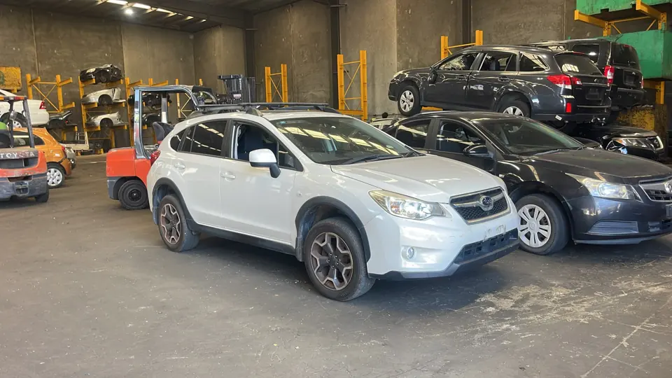 White sedan inside a workshop