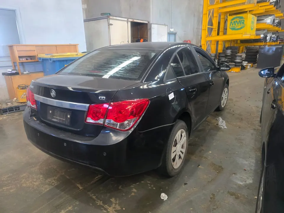 Dark sedan in a workshop