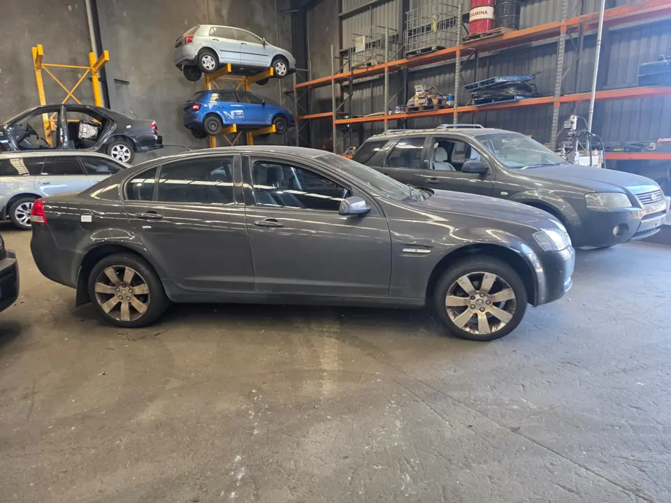 Grey sedan inside a workshop