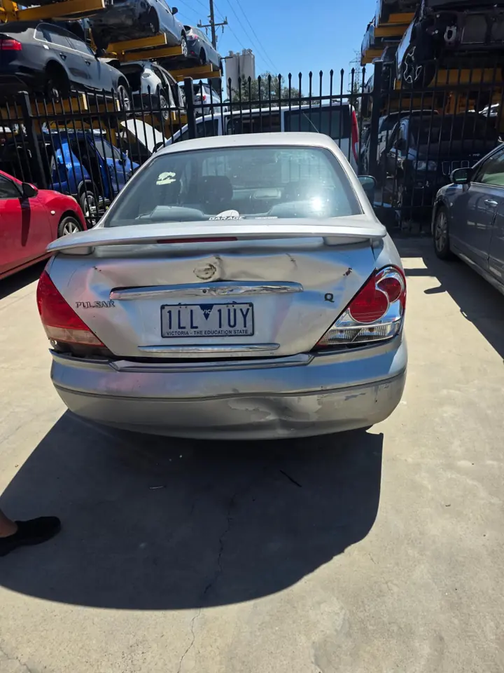 Silver hatchback in a yard