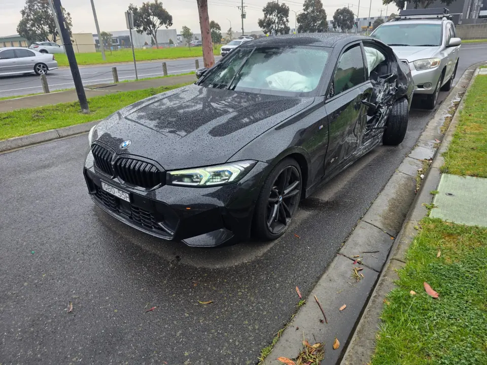 Dark sedan beside a driveway