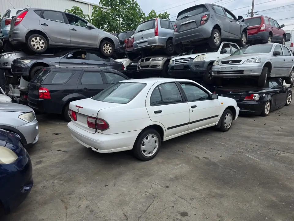 White hatchback in a vehicle yard