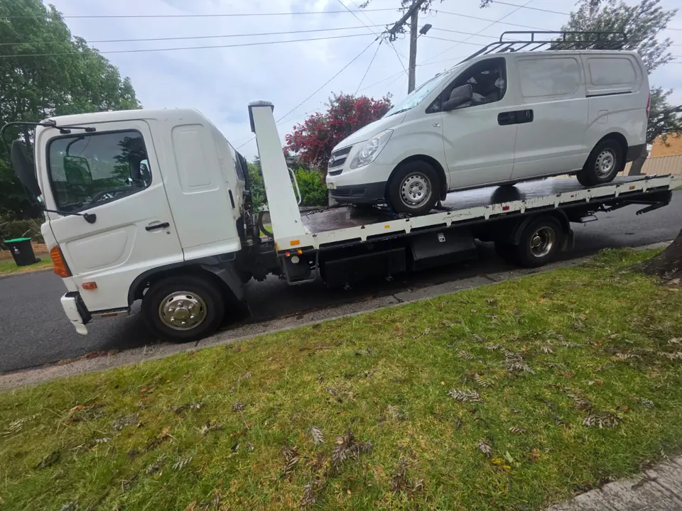 White van secured on a flatbed