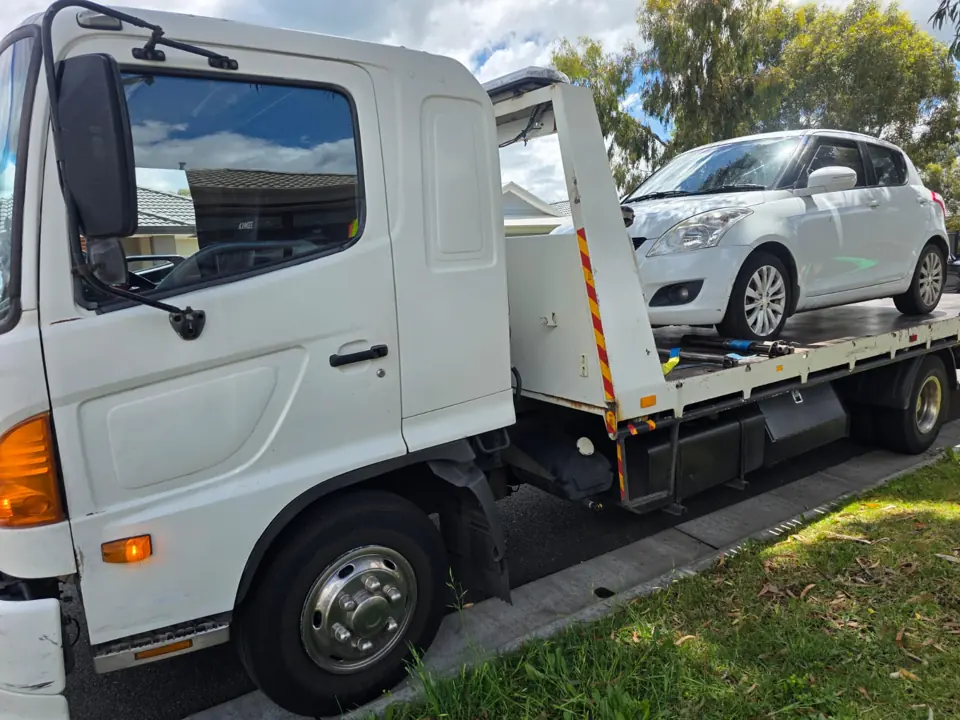 White recovery truck with a vehicle