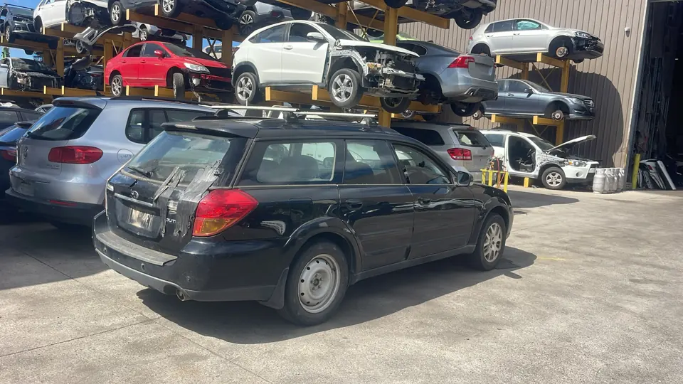 Dark hatchback among other vehicles