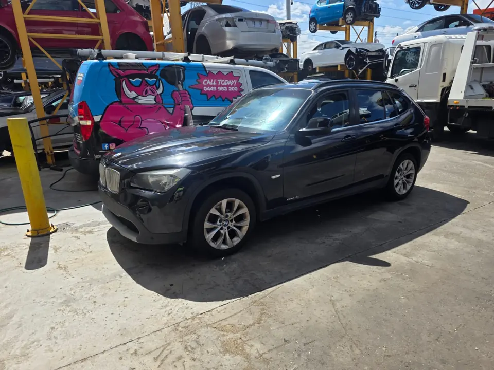 Dark car parked inside a workshop