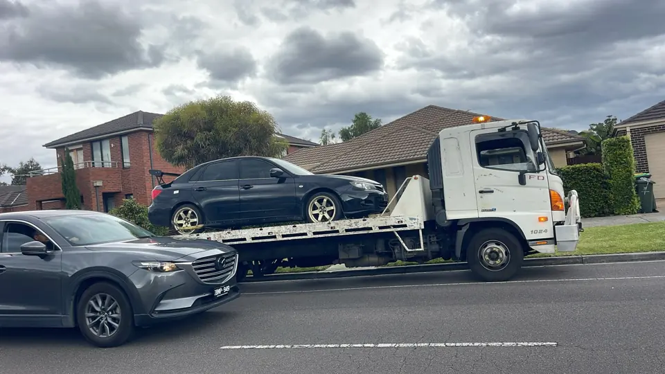 Car carried by a flatbed truck