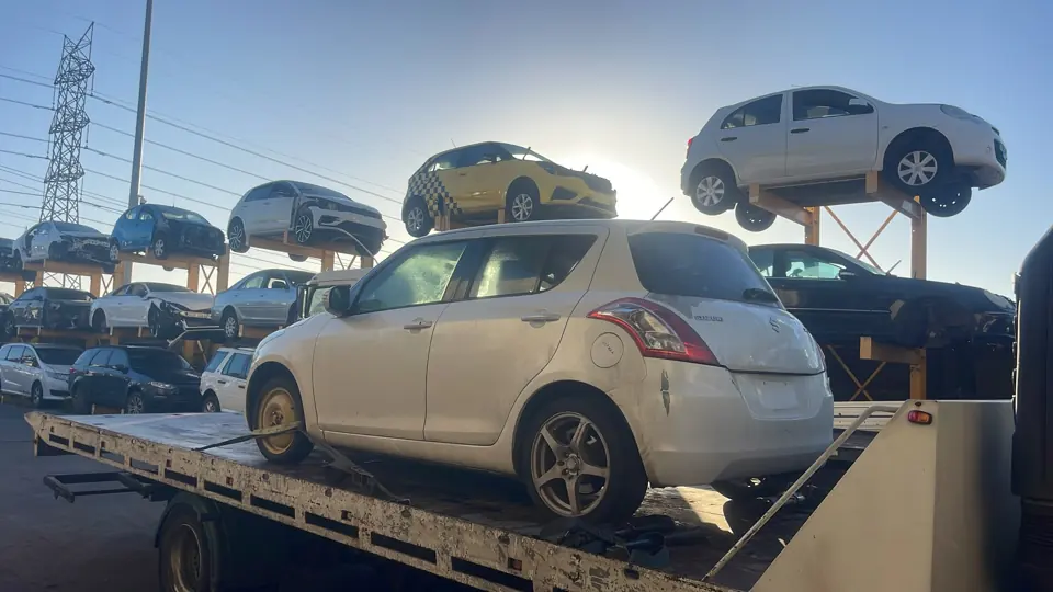 Light coloured sedan on a flatbed