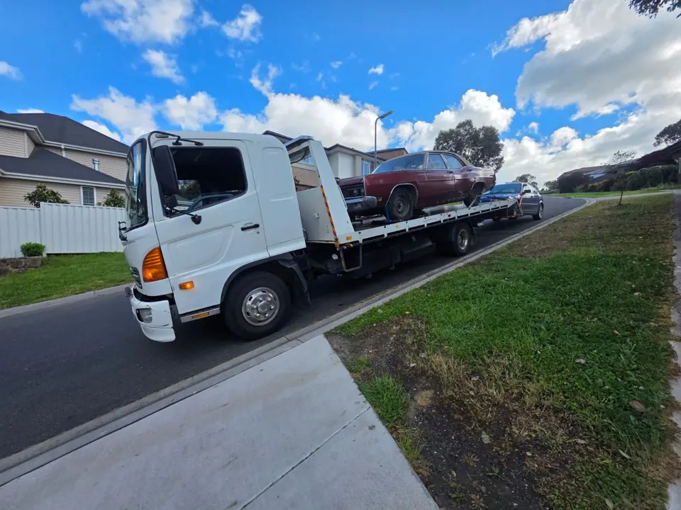 Recovery truck beside a driveway