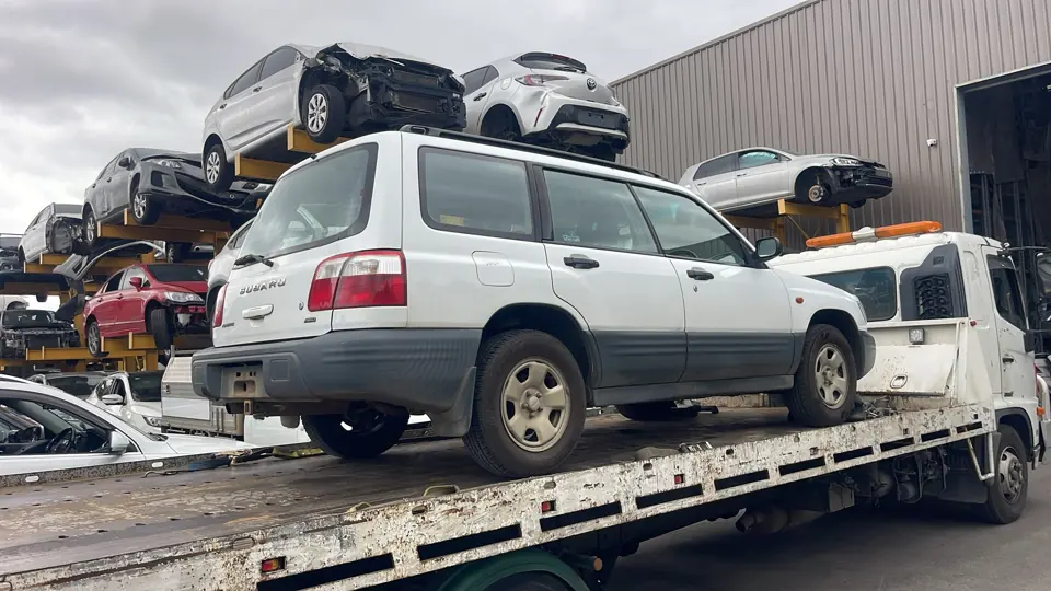 White SUV secured on a flatbed