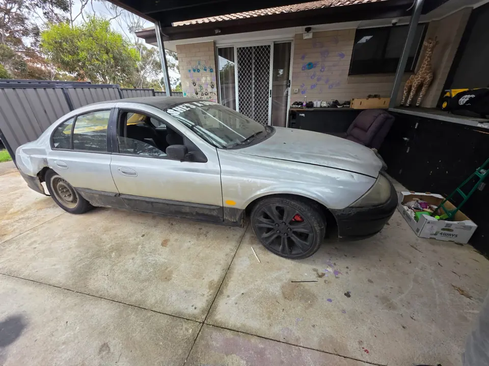 Silver sedan inside a workshop