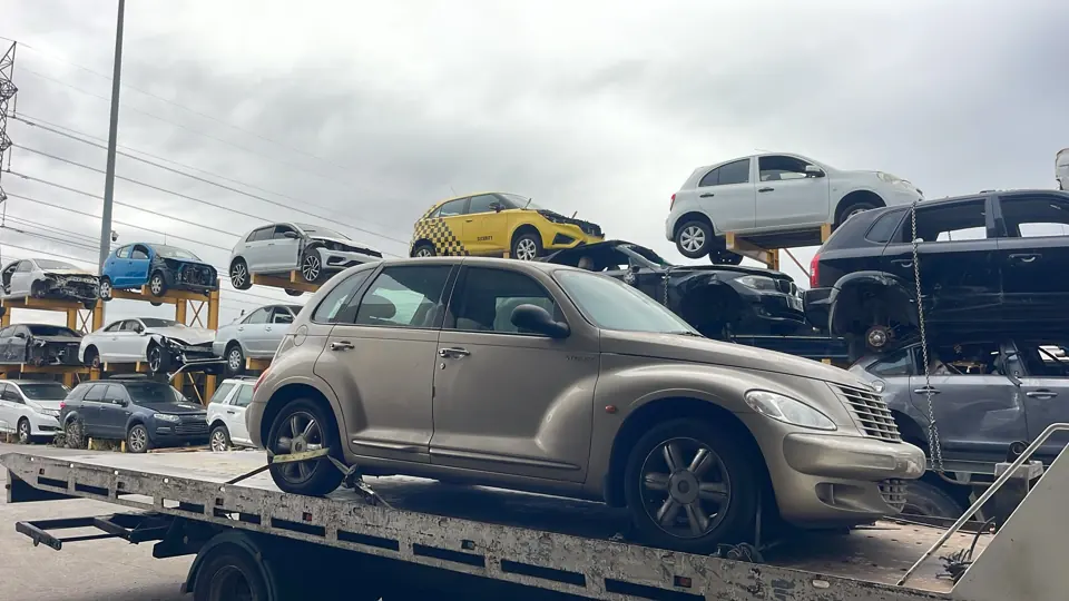 Light coloured sedan in a vehicle yard